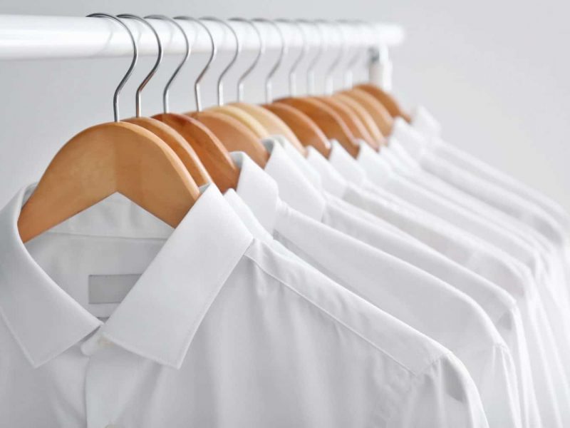 Rack With Clean Clothes On Hangers After Dry-cleaning